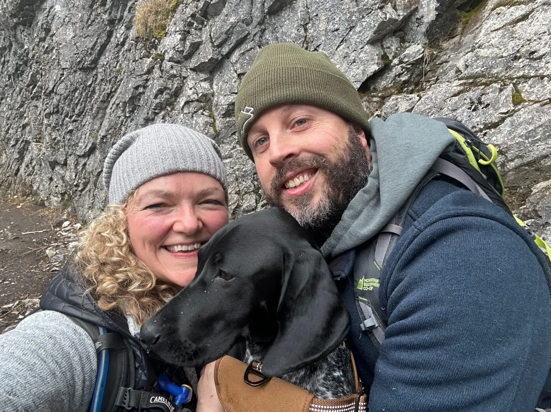 Suzy, Trevor and Nova taking a picture at the end of a long hike in the mountains.