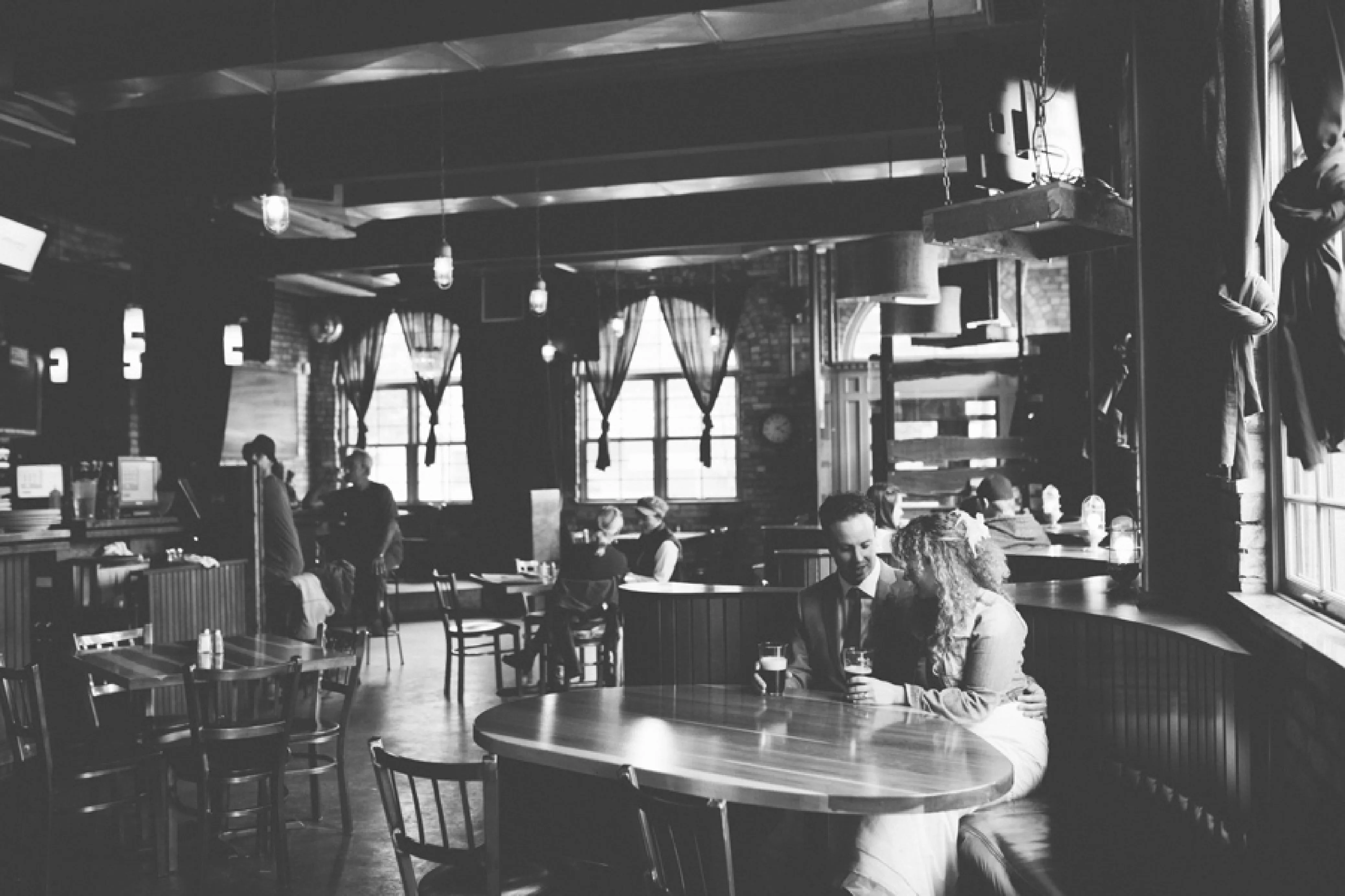 A picture of Suzy & Trevor inside of a mountain town pub sitting in a booth